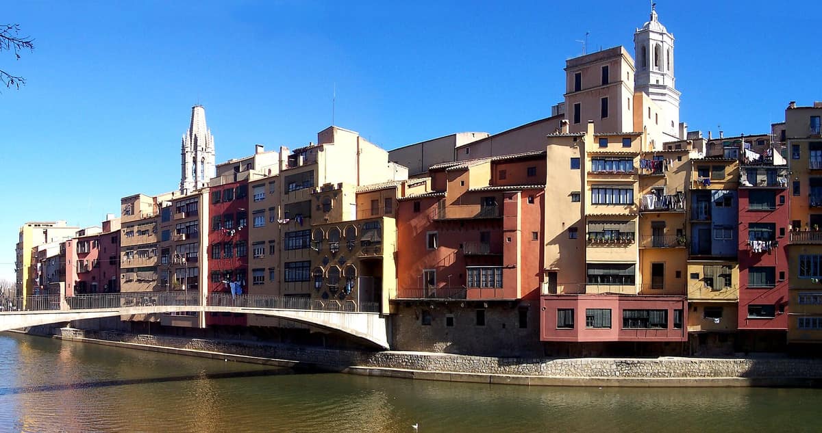 The painted houses of Girona along the Onyar river, with the cathedral above