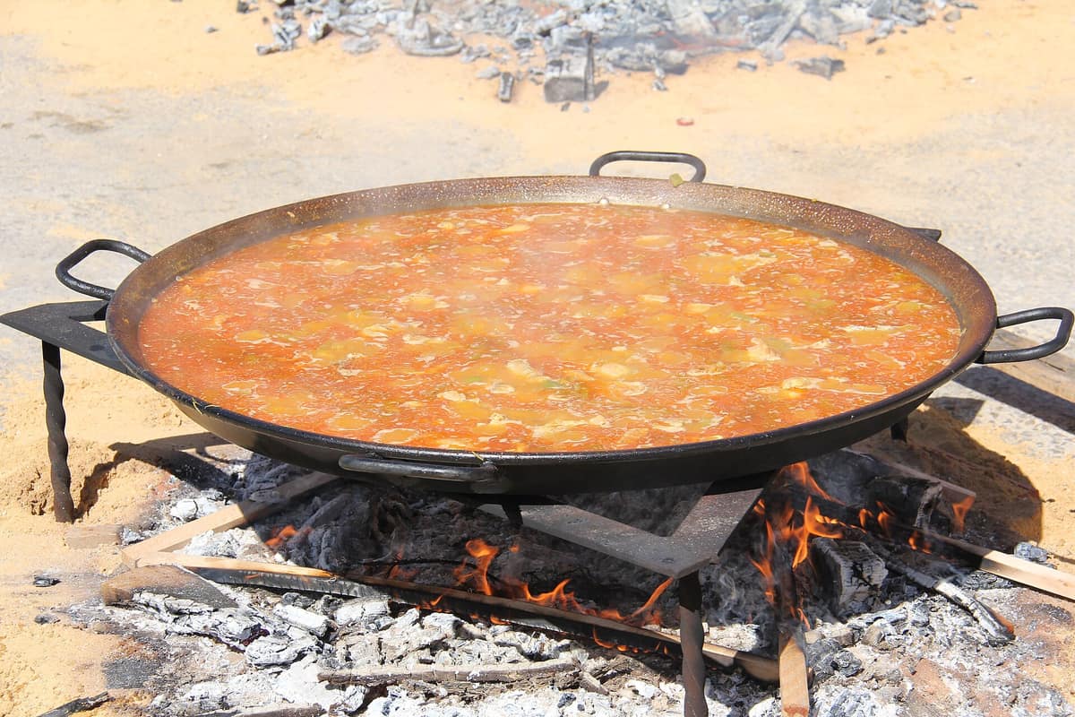A paella cooking over a wood fire near Valencia